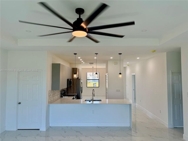 kitchen featuring range with electric stovetop, a sink, marble finish floor, light countertops, and pendant lighting