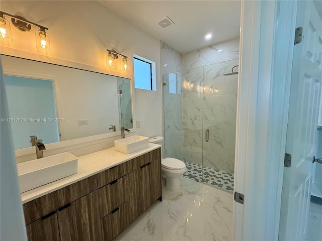 bathroom with double vanity, marble finish floor, visible vents, and a sink