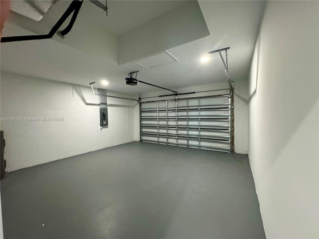 garage with a garage door opener and electric panel