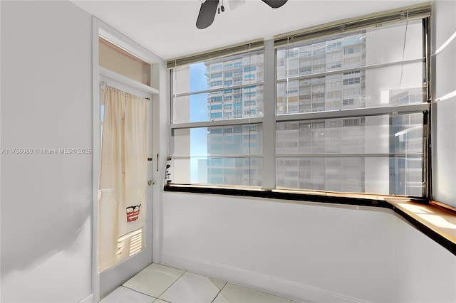 entryway featuring ceiling fan and light tile patterned flooring