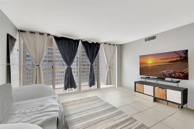 living room with light tile patterned floors and visible vents