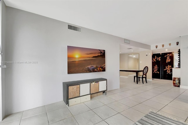 interior space featuring light tile patterned floors and visible vents