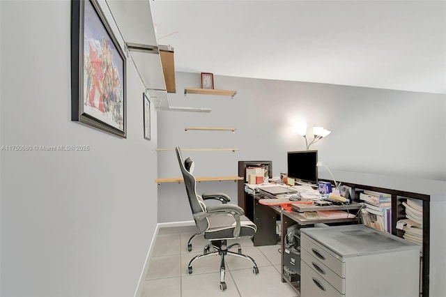 office space with baseboards and light tile patterned floors