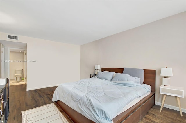 bedroom with dark wood-type flooring, visible vents, and baseboards