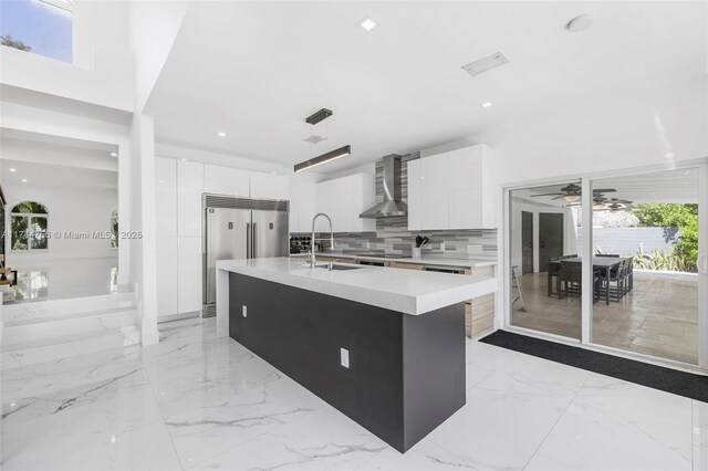 1651 SW 13th Ave, Miami, FL 33145 - kitchen with modern cabinets, wall chimney exhaust hood, stainless steel built in fridge, a sink, and recessed lighting
