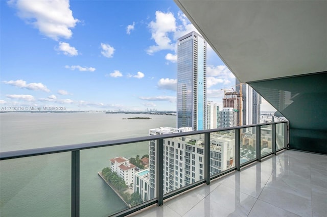 balcony featuring a view of city and a water view