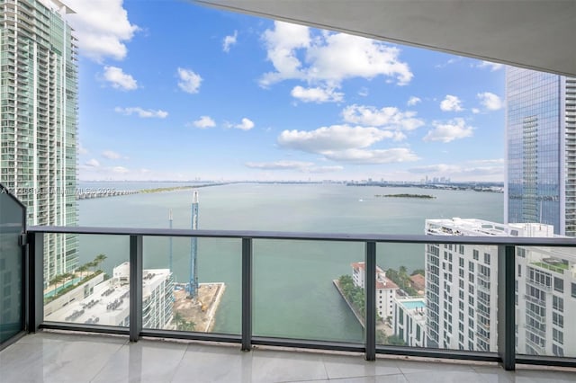 balcony with a water view and a city view