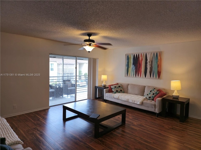 living area featuring a textured ceiling, wood finished floors, a ceiling fan, and baseboards