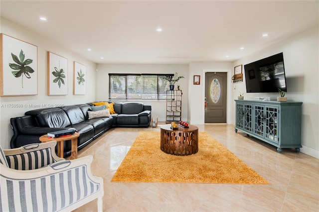 living area with recessed lighting, marble finish floor, and baseboards