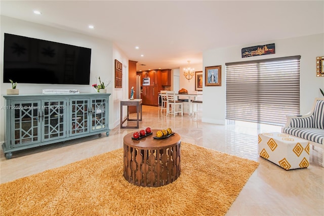 living area featuring an inviting chandelier, marble finish floor, and recessed lighting