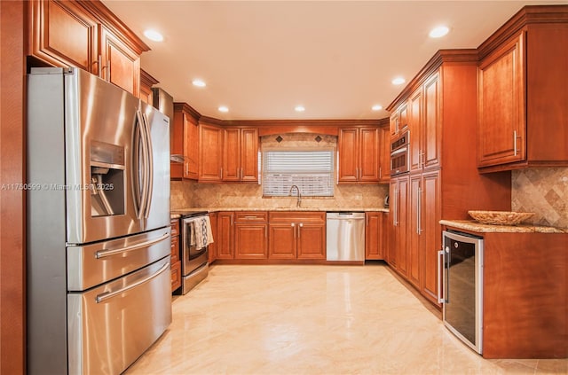 kitchen with appliances with stainless steel finishes, wine cooler, light stone countertops, and brown cabinets