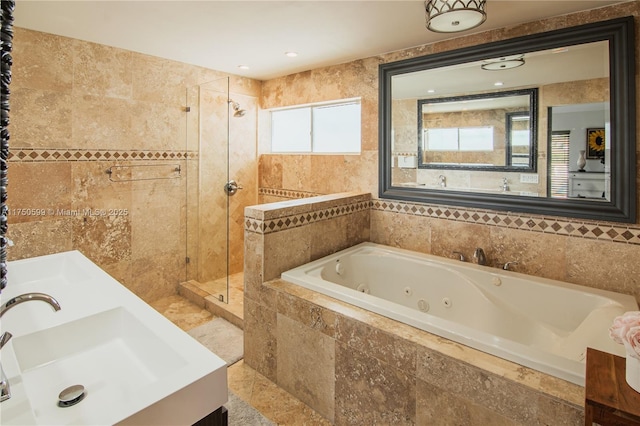 full bath featuring a stall shower, a sink, a jetted tub, and double vanity