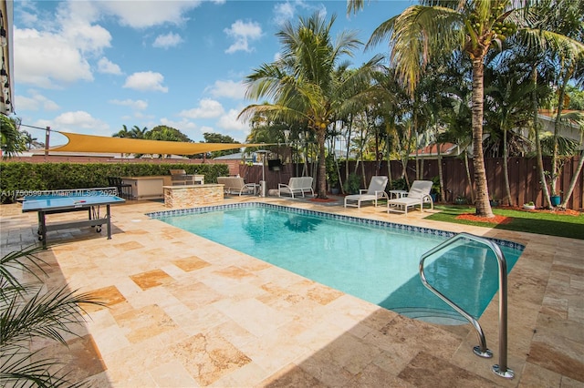 view of swimming pool featuring a patio area, area for grilling, a fenced backyard, and a fenced in pool