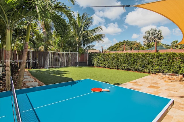 surrounding community with a patio area, an outdoor fire pit, a lawn, and a fenced backyard