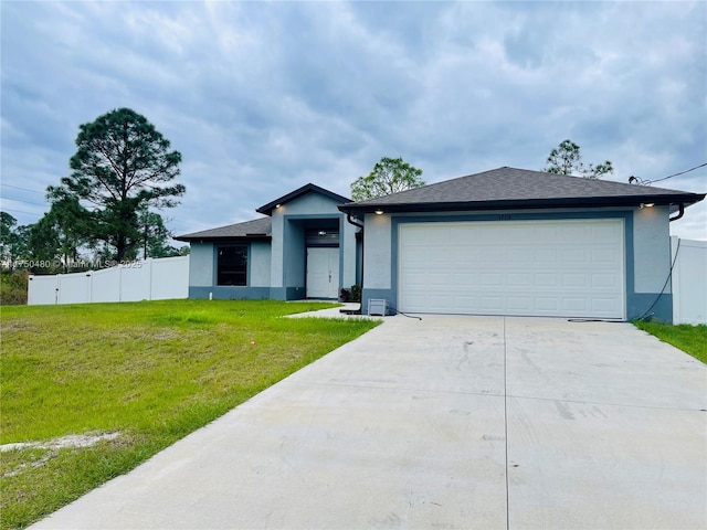 view of front of property with an attached garage, fence, driveway, stucco siding, and a front lawn