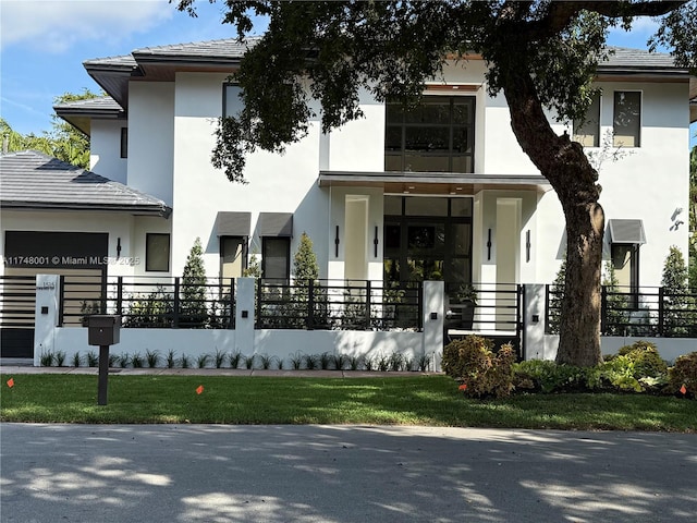 view of building exterior featuring an attached garage and fence