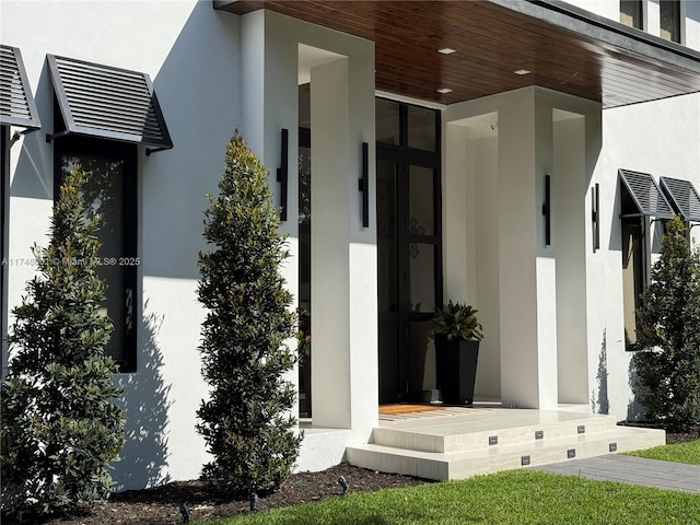 doorway to property with stucco siding