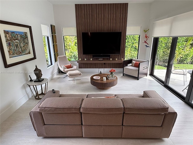 living area featuring baseboards
