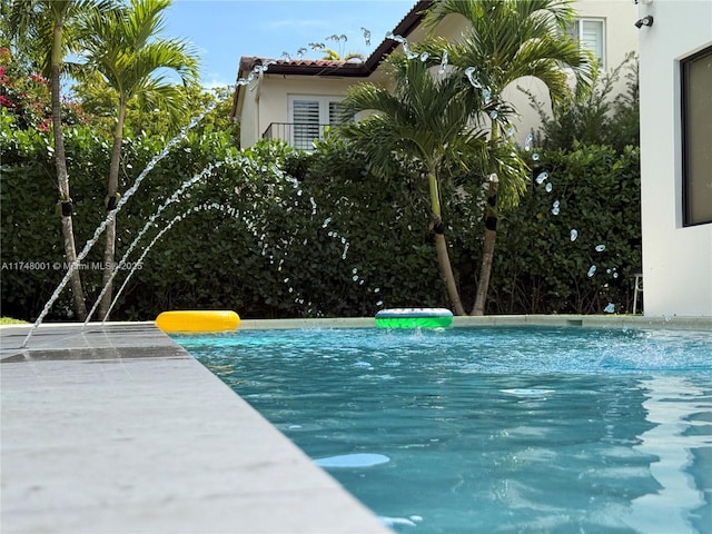 view of swimming pool featuring an infinity pool