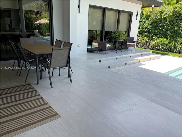 view of patio / terrace featuring an outdoor pool and outdoor dining area