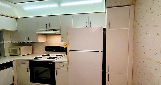 kitchen with light countertops, white appliances, wallpapered walls, and under cabinet range hood