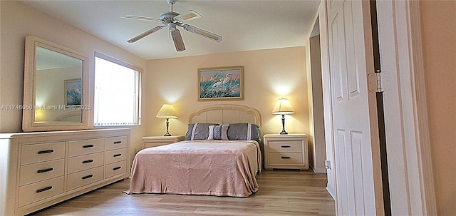 bedroom with light wood finished floors and a ceiling fan