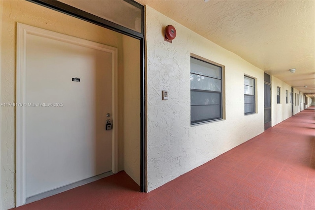 property entrance with stucco siding