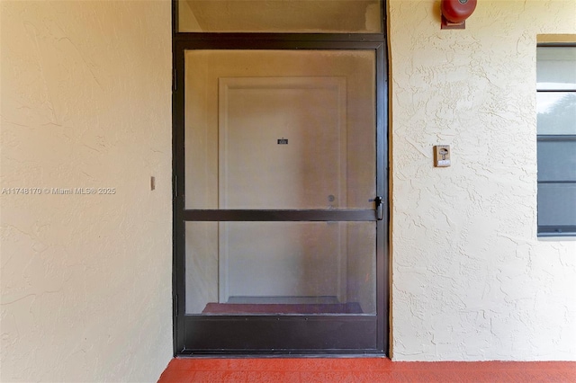 view of exterior entry featuring stucco siding