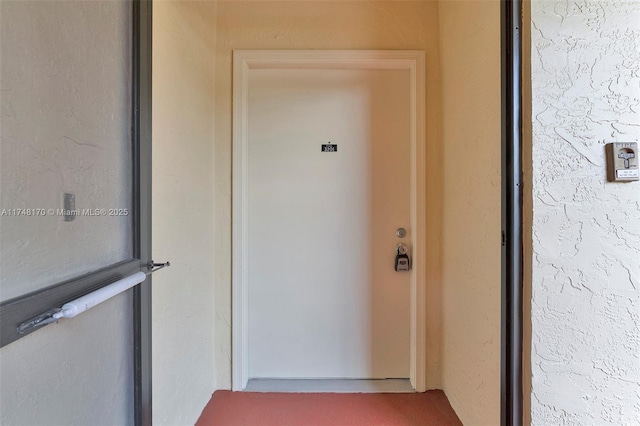 doorway to property with stucco siding