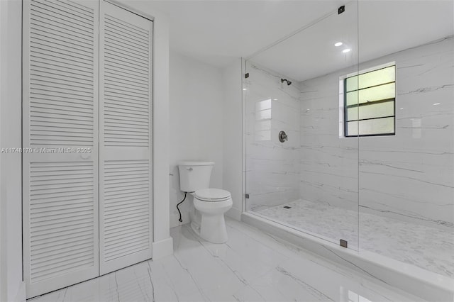 full bathroom featuring marble finish floor, a closet, a marble finish shower, and toilet