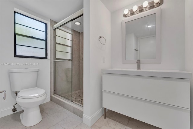 bathroom with marble finish floor, a stall shower, toilet, and baseboards