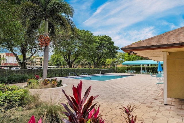 pool with a patio, a gazebo, and fence