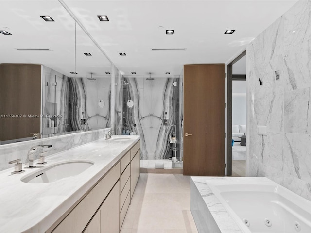 bathroom with a sink, tile walls, and a marble finish shower