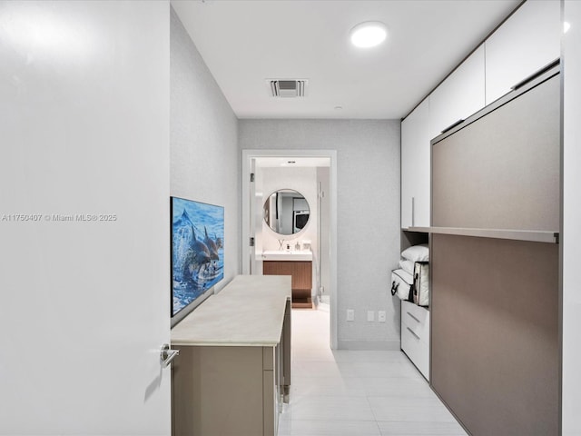 hallway with a sink and visible vents