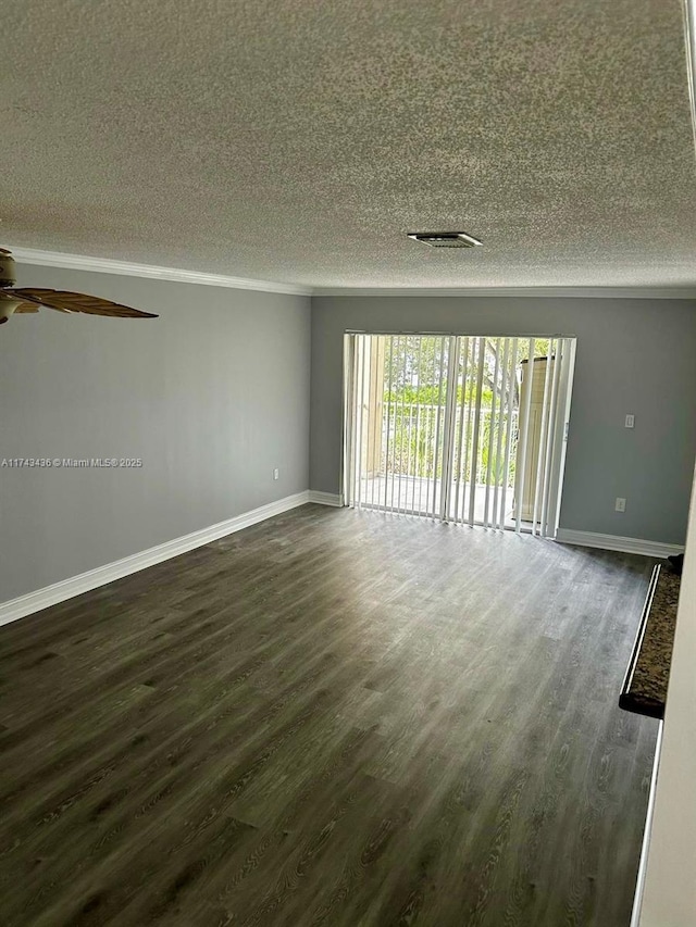 unfurnished room with dark wood-style flooring, ceiling fan, a textured ceiling, and baseboards