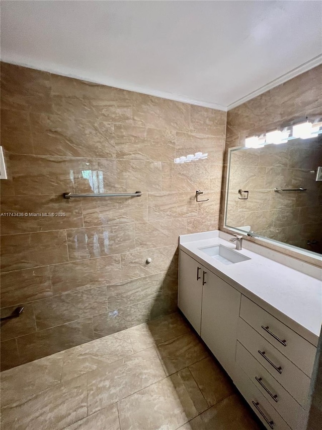 bathroom with vanity and tile walls