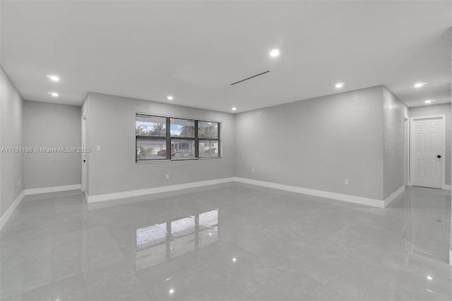 empty room featuring baseboards and recessed lighting