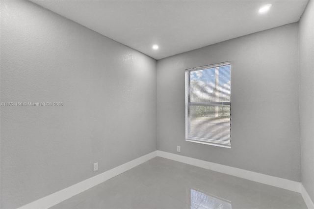 empty room with recessed lighting and baseboards