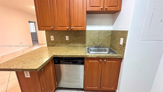 kitchen featuring brown cabinets, a sink, and stainless steel dishwasher