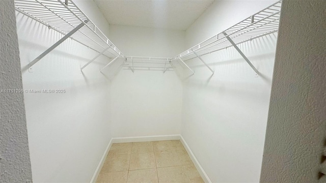 spacious closet with light tile patterned flooring