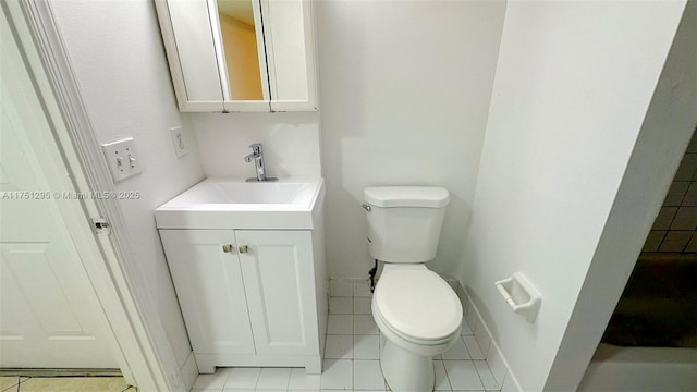 bathroom featuring tile patterned flooring, vanity, toilet, and baseboards