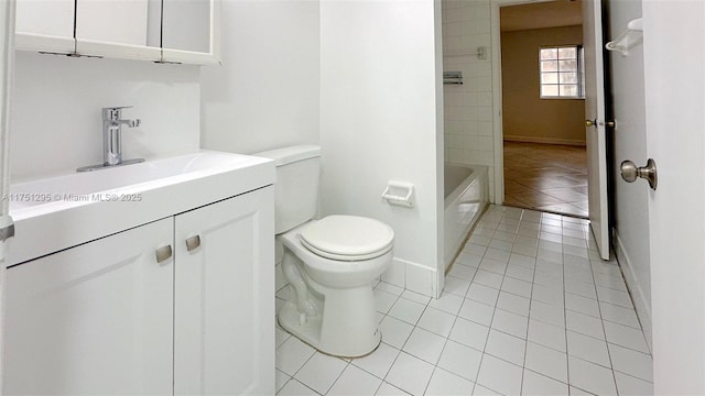 bathroom featuring tile patterned flooring, baseboards, vanity, and toilet