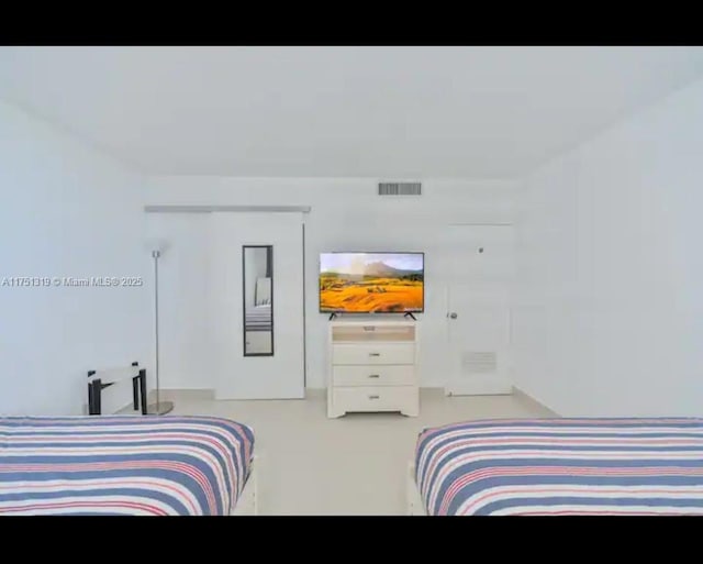 bedroom featuring concrete floors and visible vents