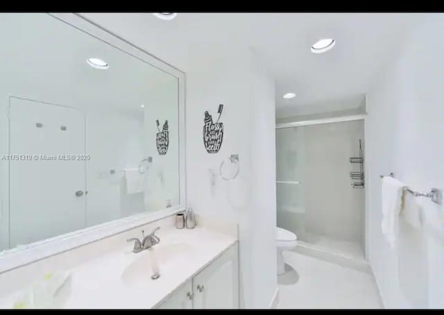 full bathroom with recessed lighting, a shower stall, toilet, and vanity