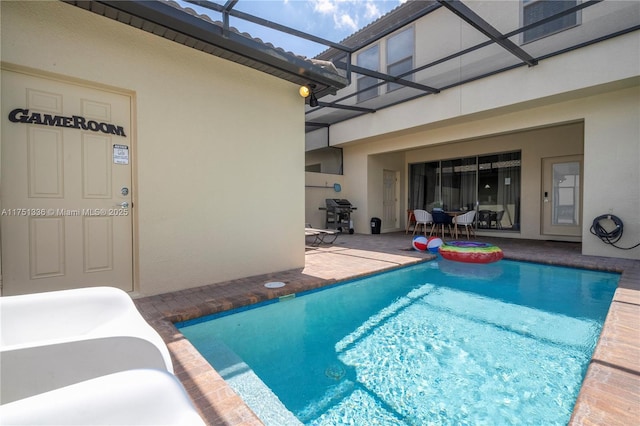 pool featuring a lanai, a grill, and a patio