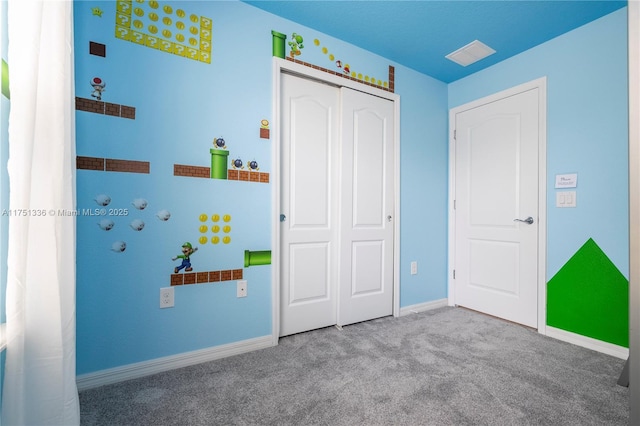 unfurnished bedroom featuring a closet, carpet, visible vents, and baseboards