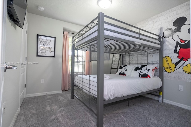 bedroom featuring baseboards and dark carpet