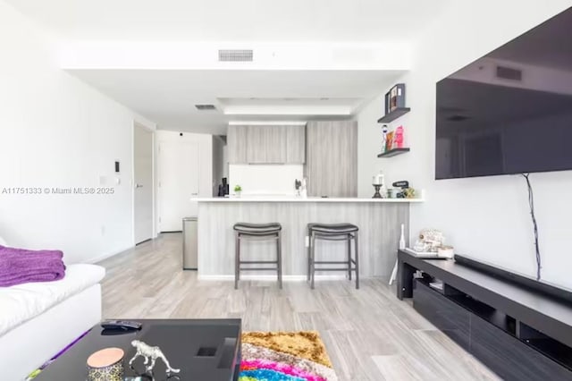 living room featuring visible vents and light wood-style flooring