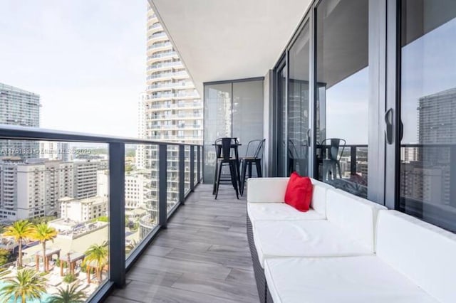 balcony with a view of city and an outdoor living space