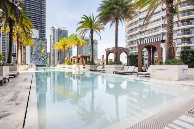 pool with a patio and a city view